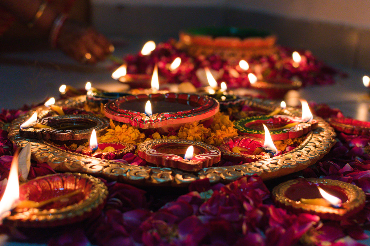 Diwali diyas with marigold rangoli